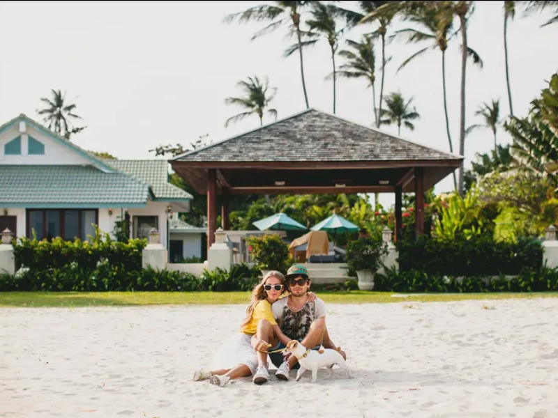 young stylish hipster couple love walking playingog-tropical-beach young stylish hipster couple love walking playingog-tropical-beach